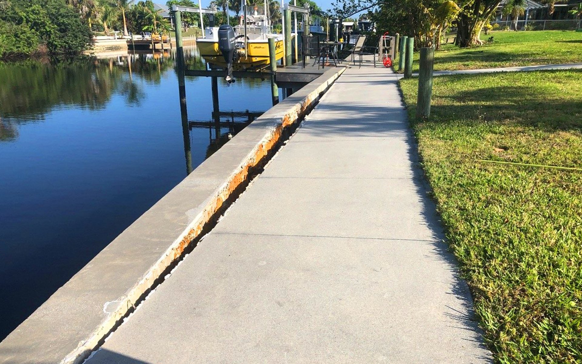 Construction crew replacing seawall along canal-front property in Stuart, FL.