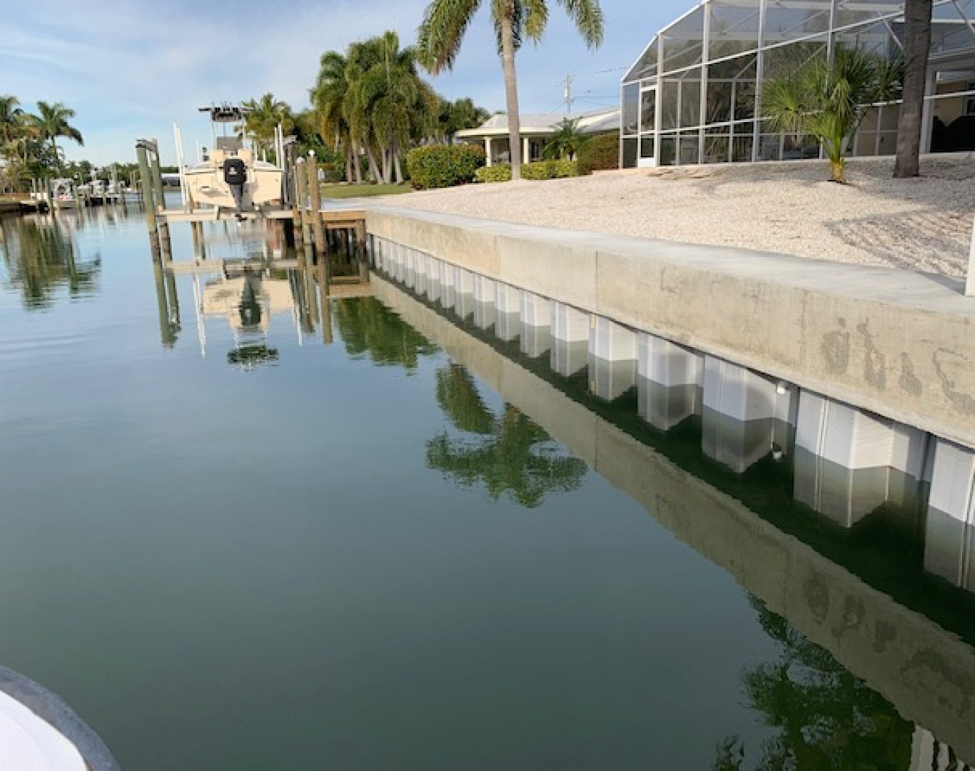 Construction crew replacing seawall along canal-front property in Stuart, FL.