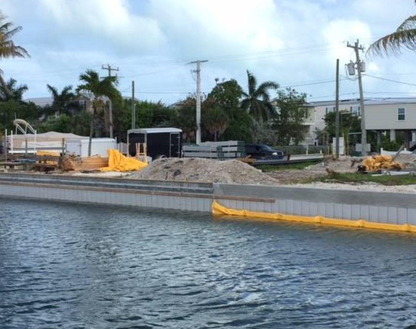 Construction crew replacing seawall along canal-front property in Stuart, FL.